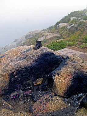 İspanya, Galiçya, Cabo Finisterre. St. James-Pilgrims Yolu 'nun sonu. 10 Ekim 2009' da deniz fenerinin orada giysilerinin parçalarını yakıyorlar.