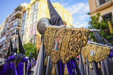 Malaga, Andalusia, Spain. Parade of the brotherhood RESCATE for Semana Santa in the Calle Agua in Malaga. March 26st 2024 clipart