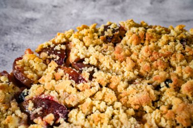 Concept food picture of a german homemade crumble plum cake clipart