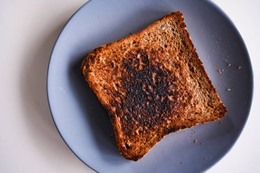 Burnt slice of toast bread isolated on white with text space without people clipart