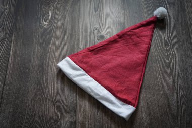 Noel Baba şapkası ahşap arka planda izole edilmiş.