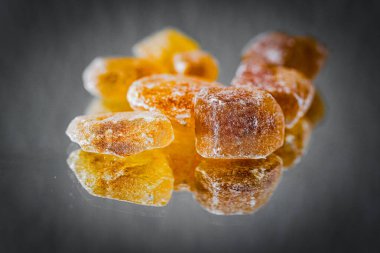 Detail of brown sugar rock candy kandis on a neutral background clipart