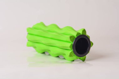 Studio shot of a textured foam roller used for fascia training, muscle recovery, and physical therapy