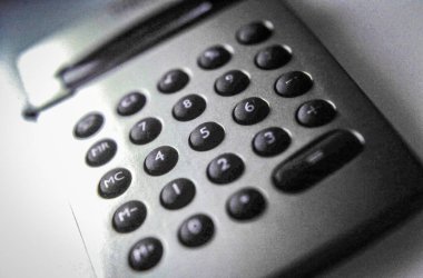 Almanya. 4 Ekim 2025. Eğitici, finansal ve iş konuları için hesap makinesi klavyesinin yaratıcı ürün çekimi