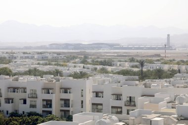 Muscat / Oman  February 13, 2020. View across the Al Mouj (The Wave) real estate development in Muscat, with Muscat International airport in the background clipart