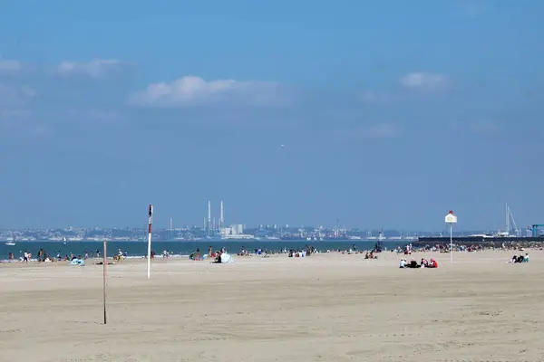 stock image Deauville / France  September 14, 2019. A view across the sands of Deauville beach and the English Channel towards the industrial area of Le Havre