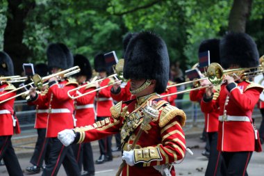 Members of the Household Division march down Birdcage Walk, central London, during rehearsals for Trooping the Colour on 31 May 2017. clipart