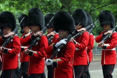 Members of the Household Division march down Birdcage Walk, central London, during rehearsals for Trooping the Colour on 31 May 2017. clipart