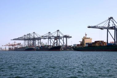 Container vessels from United Arab Shipping Company (UASC) and NYK Line docked at the Oman International Container Terminal in Sohar, Oman, on 9 August 2017. clipart