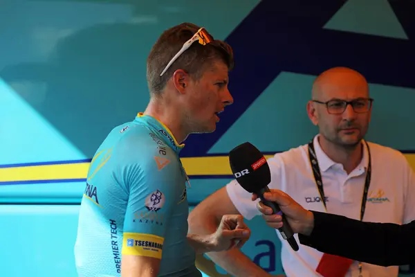 stock image Jakob Fuglsang of Astana warms down following the finish at Longwy of stage 3 of the 2017 Tour de France while conducting a media interview