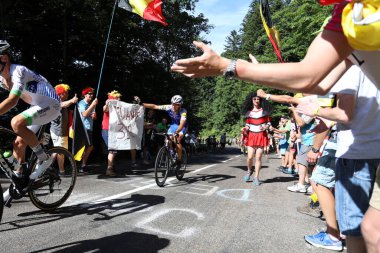 Belgium's Philippe Gilbert of the Quick-Step Floors team waves as he passes fans wishing him a happy birthday, on the climb to the summit finish at La Planche des Belles Filles on stage 5 of the 2017 Tour de France  clipart