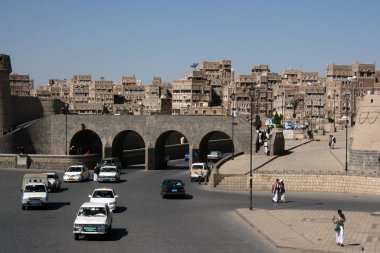 Cars drive through the old town of Sanaa, Yemen clipart