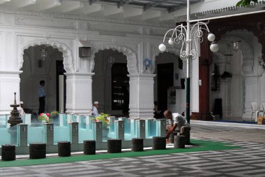 A man washes before praying at the Jummah Masjid (mosque) in Port Louis, Mauritius clipart