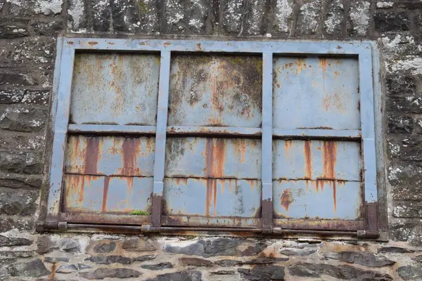 stock image rusty gate with an old wall.