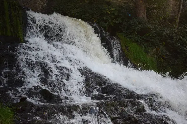 stock image waterfall on dark rocks with wild water