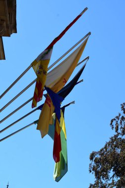 colorful flags on a blue sky background clipart