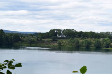 beautiful view of the lake with the church of Weinfelden clipart