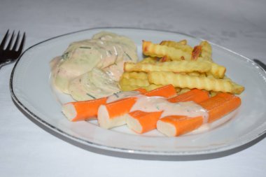 surimi with fries and a cream sauce salad clipart