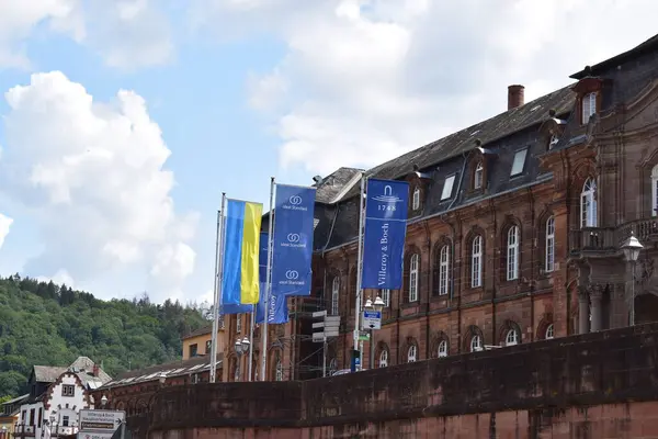 stock image flags in front of an old factory