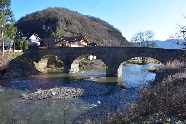 stock image a small bridge over the river in the mountains