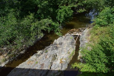 a beautiful view of the river flowing through the rocks clipart