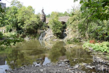 the old bridge across a waterfall during drought clipart