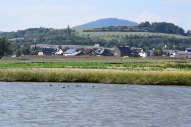 the village Thuer in the Eifel behind a swamp lake clipart