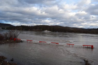 flooded ferry ramp and barrier at the Rhine clipart