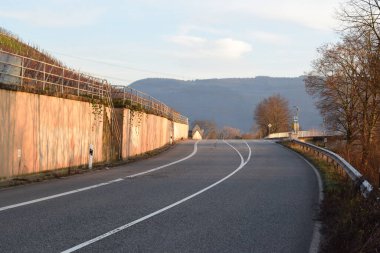 road through Mosel valley at golden hour in winter clipart