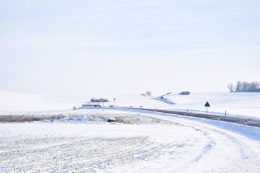 a beautiful shot of a road in the snow