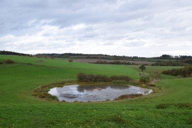 Trautzberger Maar in autumn light clipart