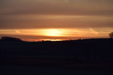 Turuncu gökyüzü ve akşam bulutları ile renkli gün batımı