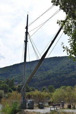 a vertical shot of a wooden boat crane clipart