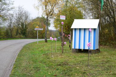 pink October decoration at the village exit of Remefling clipart