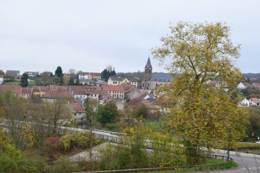 view across the village Sarreinsming in autumn clipart