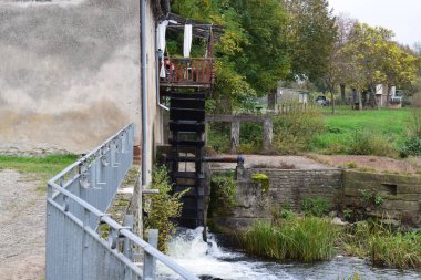 old water mill and mill on a river in the autumn clipart