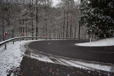 road with snow in winter forest clipart