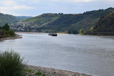 Rhine with a cargo ship at the south end of the Loreley clipart