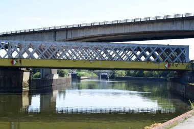 the bridges on two levels crossing each other and the Moselle in Thionville clipart