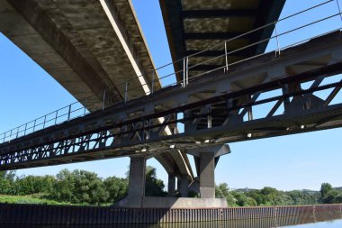 the bridges on two levels crossing each other and the Moselle in Thionville clipart