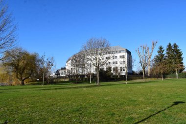 white buildings with winter trees clipart