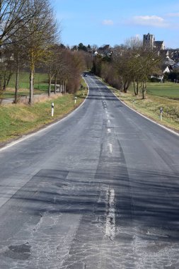 avenue into Muenstermaifeld in the Eifel clipart