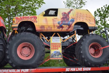 a big monster truck on a road in the amusement park