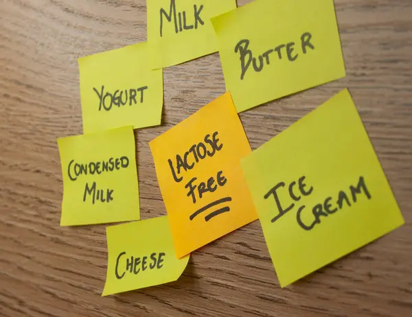 stock image lactose-free dairy product concept with office notes and one that stands out with a phrase 