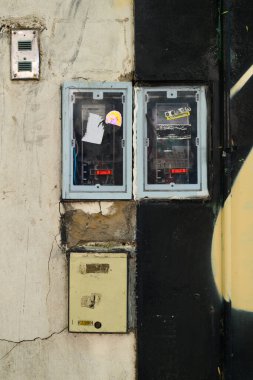 Büyük bir binanın yan tarafına yerleştirilmiş iki elektrik kutusu var. Genel tasarım ve kullanım gücünü arttırıyor.