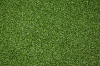 Yapay ot, kaplama. Yapay yeşil çimen paspası, üst manzara. Doku. Geçmişi. Suni çim, yapay liflerden yapılmış yüzey. Düz yeşil çimen dokusu. Kısa çimenler. Stok fotoğrafı