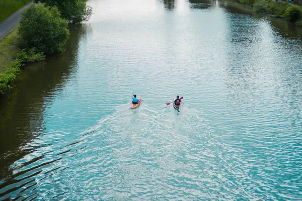 stock image Kayaks Rowing on the River Stream Along a Park