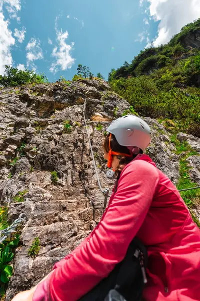 stock image Woman Climber with Helmet Looking up the Natural Stone Rock Climbing Wall Ready for Action