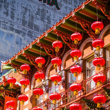 Red Chinese lanterns adorn a traditional building, highlighting cultural celebration and festivity. Urban setting emphasizes historic and architectural charm, creating a lively and colorful ambiance clipart