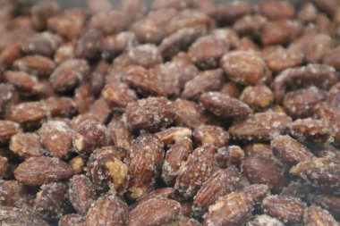 Candied Almonds with Crystallized Sugar Coating: A close-up of roasted almonds coated in a delicious crystallised sugar layer. Chocolate Ingredient, High-quality Stock Image clipart